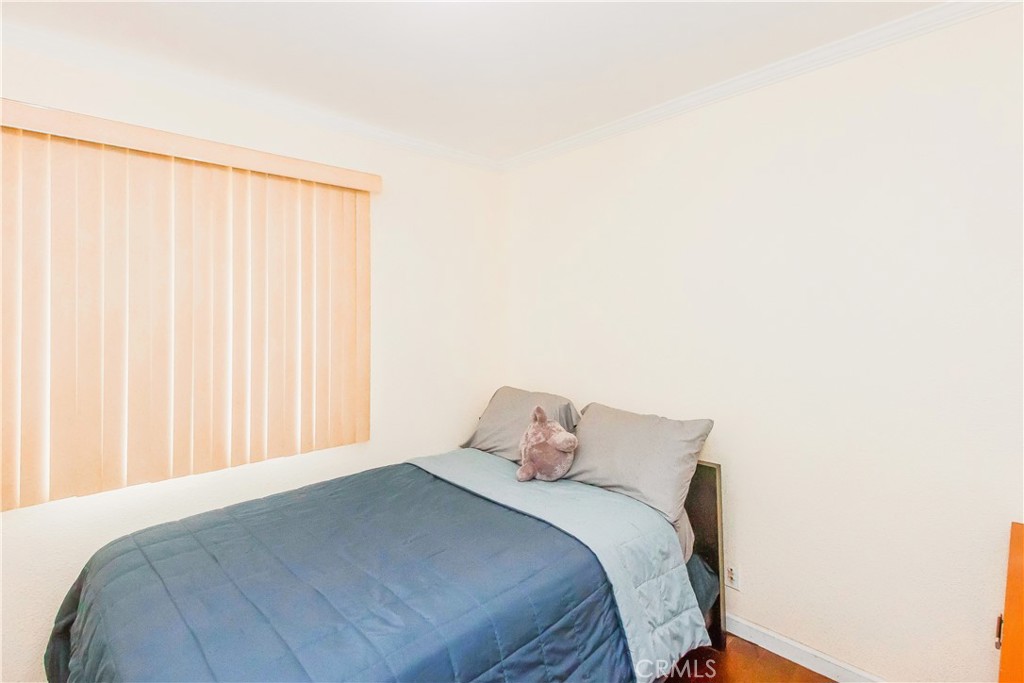 4635 Merced Avenue Baldwin Park, CA 91706 - Photo 10 of 18 a bedroom with a bed and a curtain
