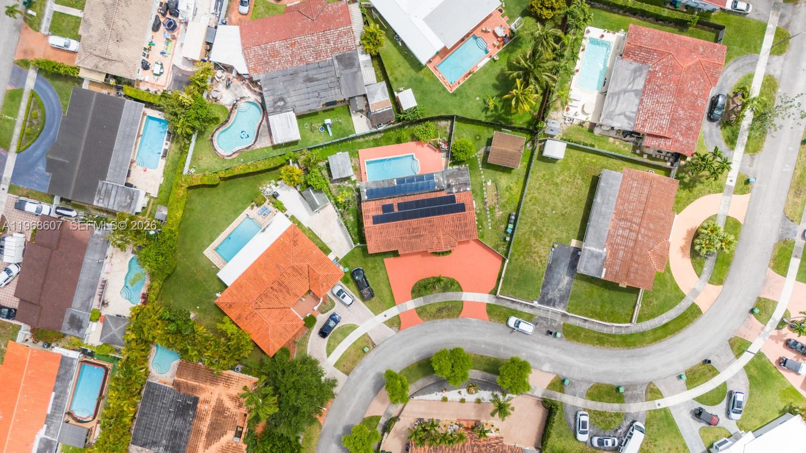 an aerial view of a houses with a swimming pool