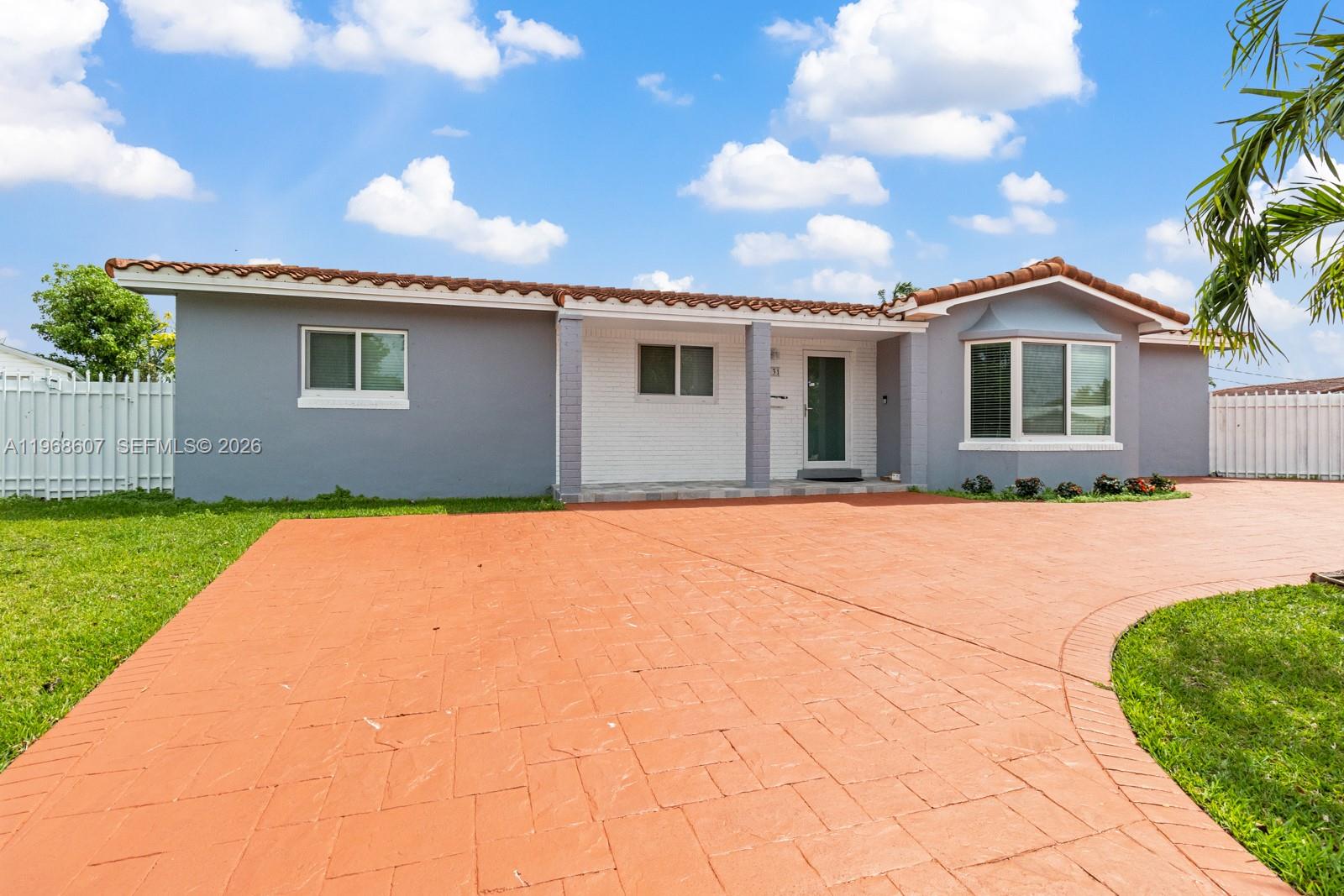 2131 Southwest 98th Place, Unit 1 Miami, FL 33165 - Photo 2 of 8 a front view of a house with a garden