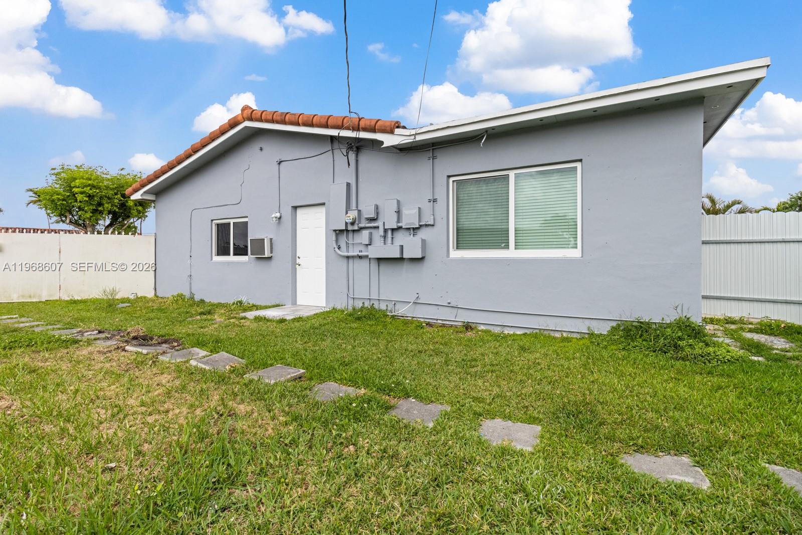 2131 Southwest 98th Place, Unit 1 Miami, FL 33165 - Photo 3 of 8 a front view of house with yard and green space