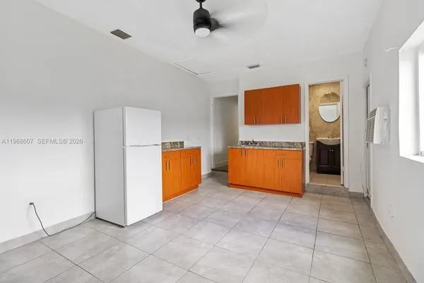 a kitchen with granite countertop a refrigerator and a sink