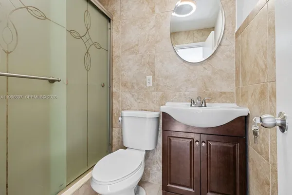 a bathroom with a sink a toilet and a mirror