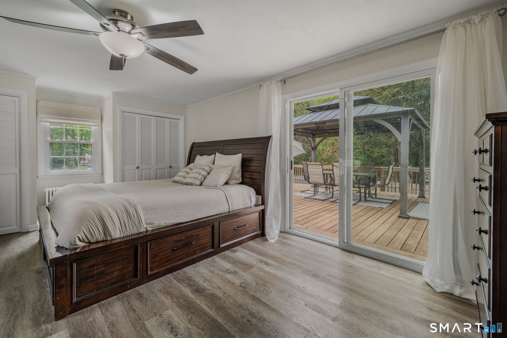 65 Flat Iron Road Guilford, CT 06437 - Photo 14 of 40 Primary bedroom with full bathroom and sliders off to the private back deck.