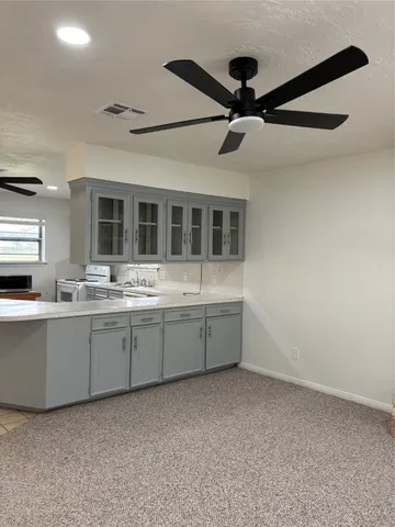 a large white kitchen with a sink