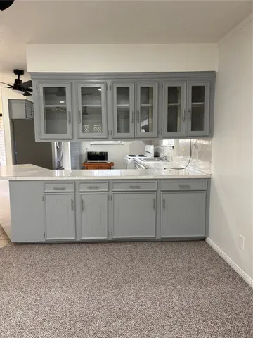 a kitchen with a sink and cabinets