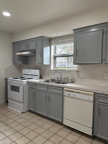 a kitchen with a sink cabinets and window