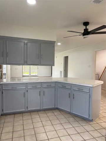a metallic refrigerator freezer and a stove sitting inside of a refrigerator