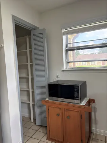 an empty room with a window and a ceiling fan