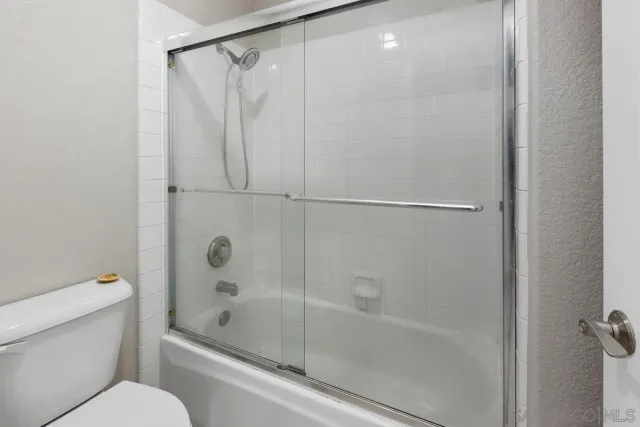 a bathroom with a shower and a toilet