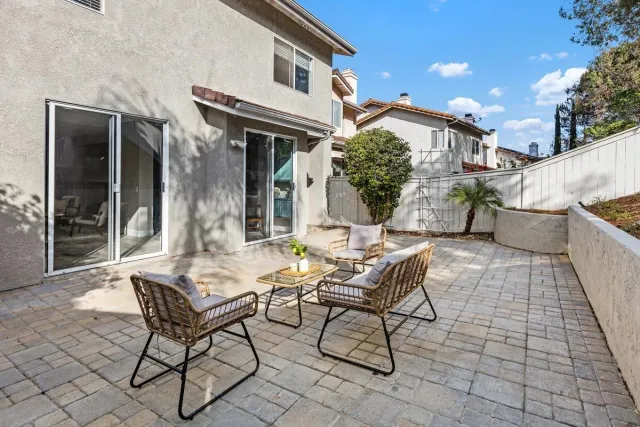 a backyard of a house with table and chairs
