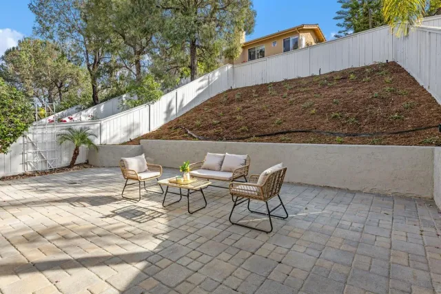a backyard of a house with table and chairs