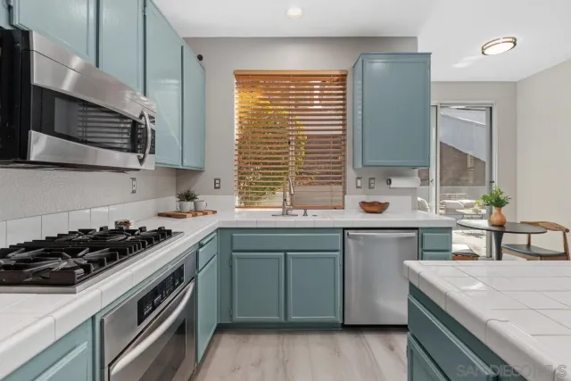 a kitchen with a sink stove top oven and cabinets