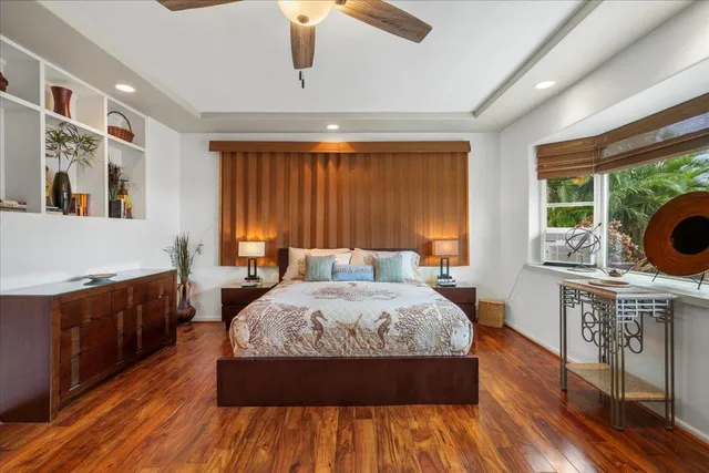 a bedroom with furniture and a large window