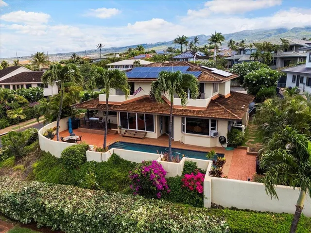 an aerial view of multiple houses with a yard