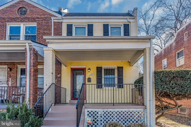 a view of a brick house with large windows