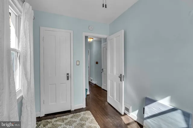 a view of a room with wooden floor and bathroom