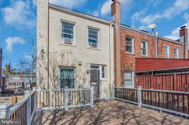 a view of a brick house with large windows
