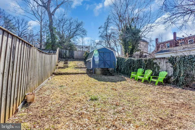 a view of a house with a yard and wooden fence