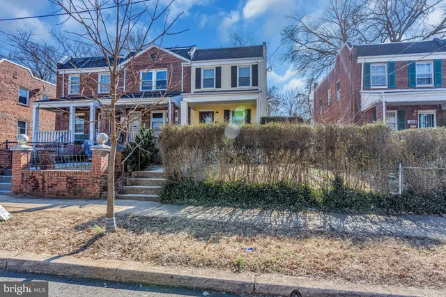 a front view of a residential apartment building with a yard