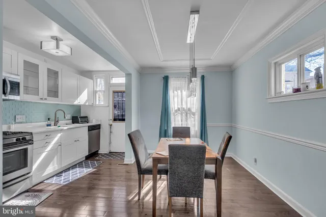 a view of a dining room with furniture and a chandelier