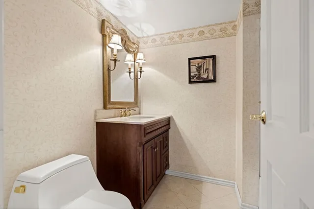 a bathroom with a toilet sink and mirror