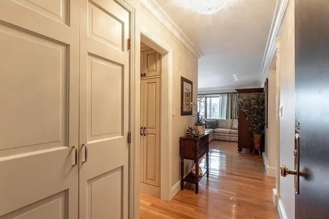 a view of a hallway with dining area and glass door