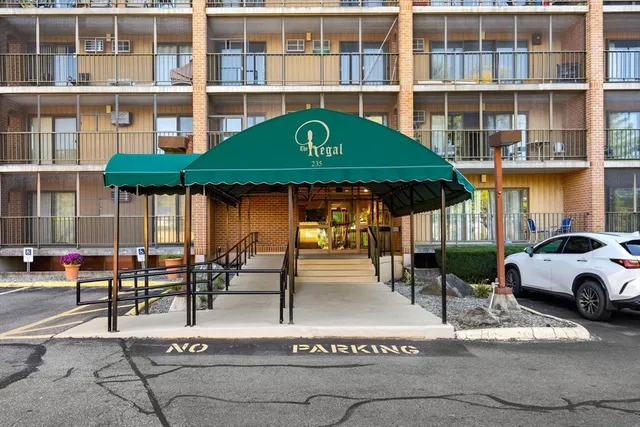 a front view of a building with sitting area