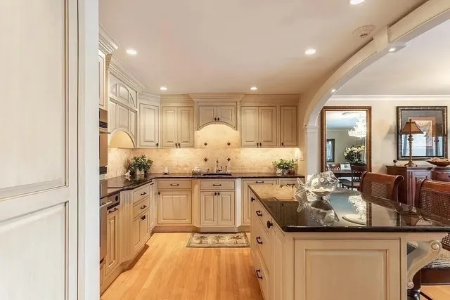 a kitchen with counter top space sink stove and cabinets