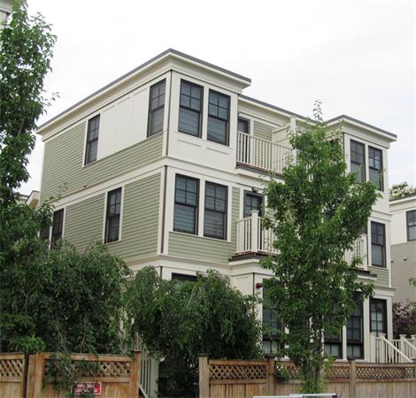 a front view of a house with plants