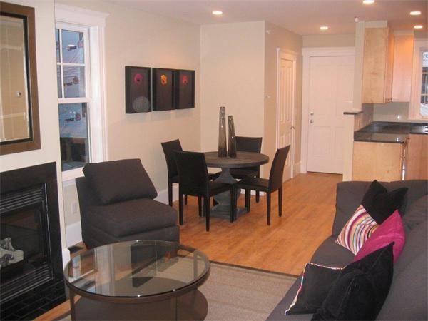 16 Decatur Street, Unit 16 Cambridge, MA 02139 - Photo 3 of 9 a living room with furniture a flat screen tv and kitchen view
