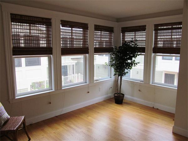 16 Decatur Street, Unit 16 Cambridge, MA 02139 - Photo 5 of 9 a view of an empty room with a window and wooden floor