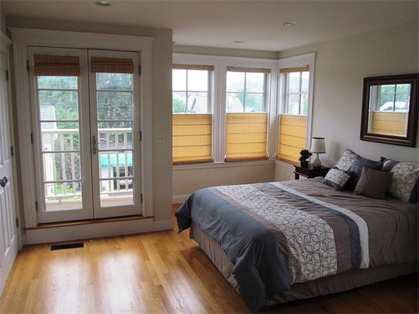 16 Decatur Street, Unit 16 Cambridge, MA 02139 - Photo 6 of 9 a bedroom with a bed and a large window