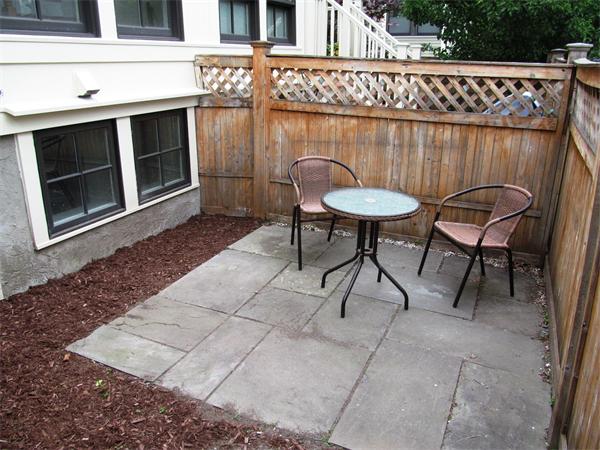 16 Decatur Street, Unit 16 Cambridge, MA 02139 - Photo 8 of 9 a backyard of a house with table and chairs