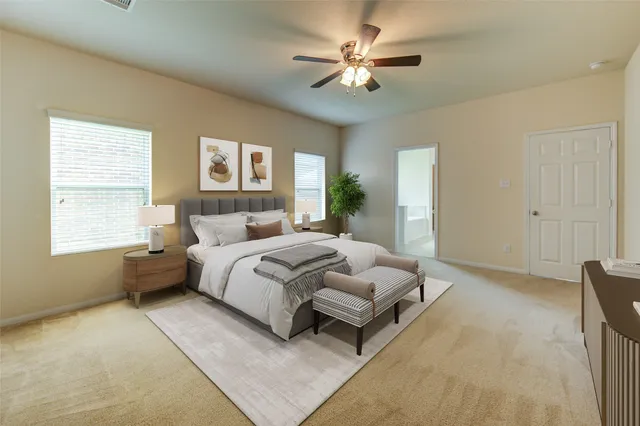 a spacious bedroom with a bed painting on wall and windows