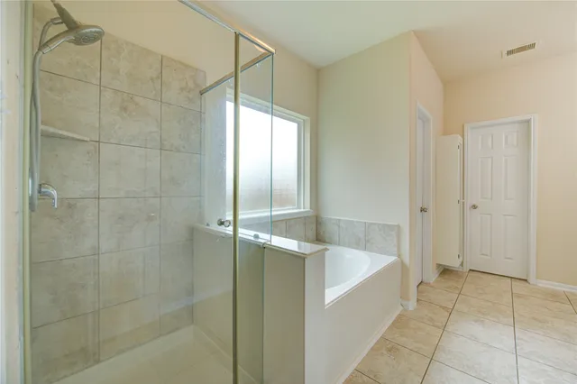 a bathroom with a bathtub and a shower