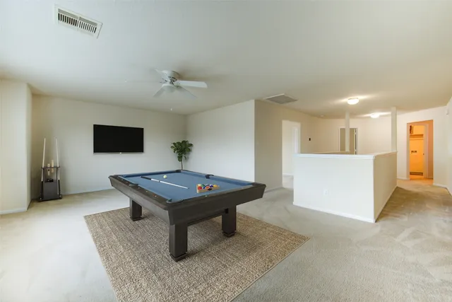 a room with furniture and pool table