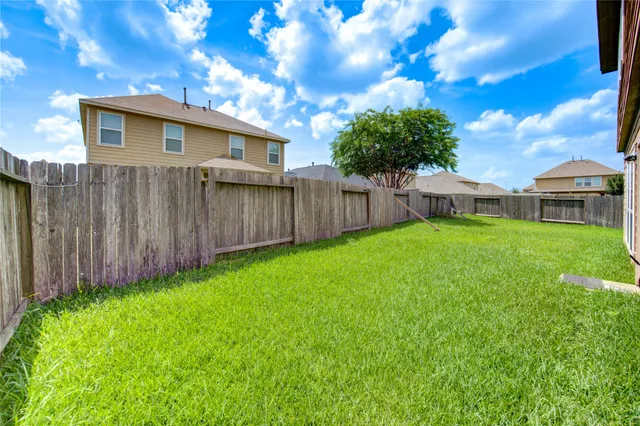a view of a house with a backyard
