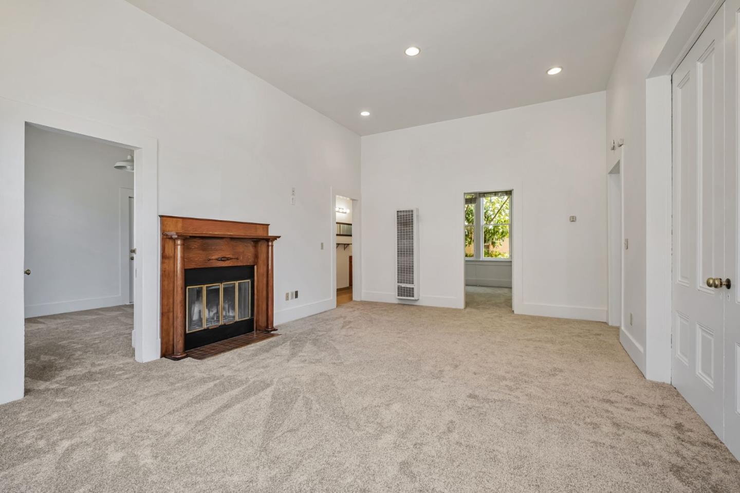 120 Maple Street Santa Cruz, CA 95060 - Photo 17 of 29 an empty room with a window and a fireplace
