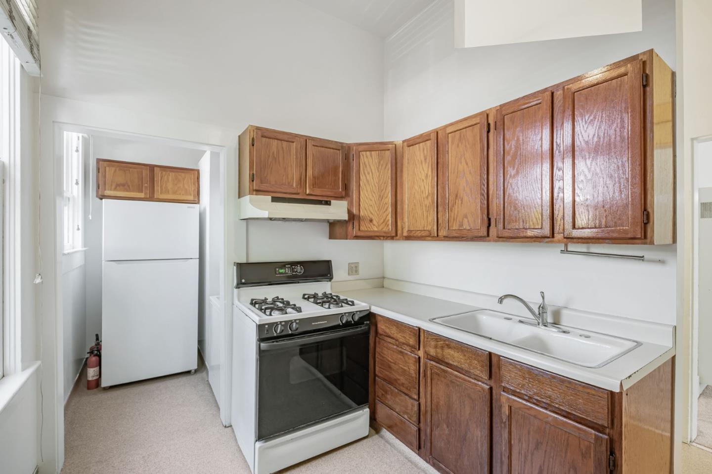 120 Maple Street Santa Cruz, CA 95060 - Photo 23 of 29 a kitchen with stainless steel appliances granite countertop a sink stove and refrigerator