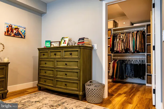 a view of walk in closet with clothes and shoes