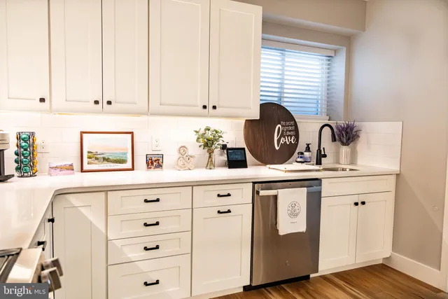 a kitchen with cabinets appliances and a window