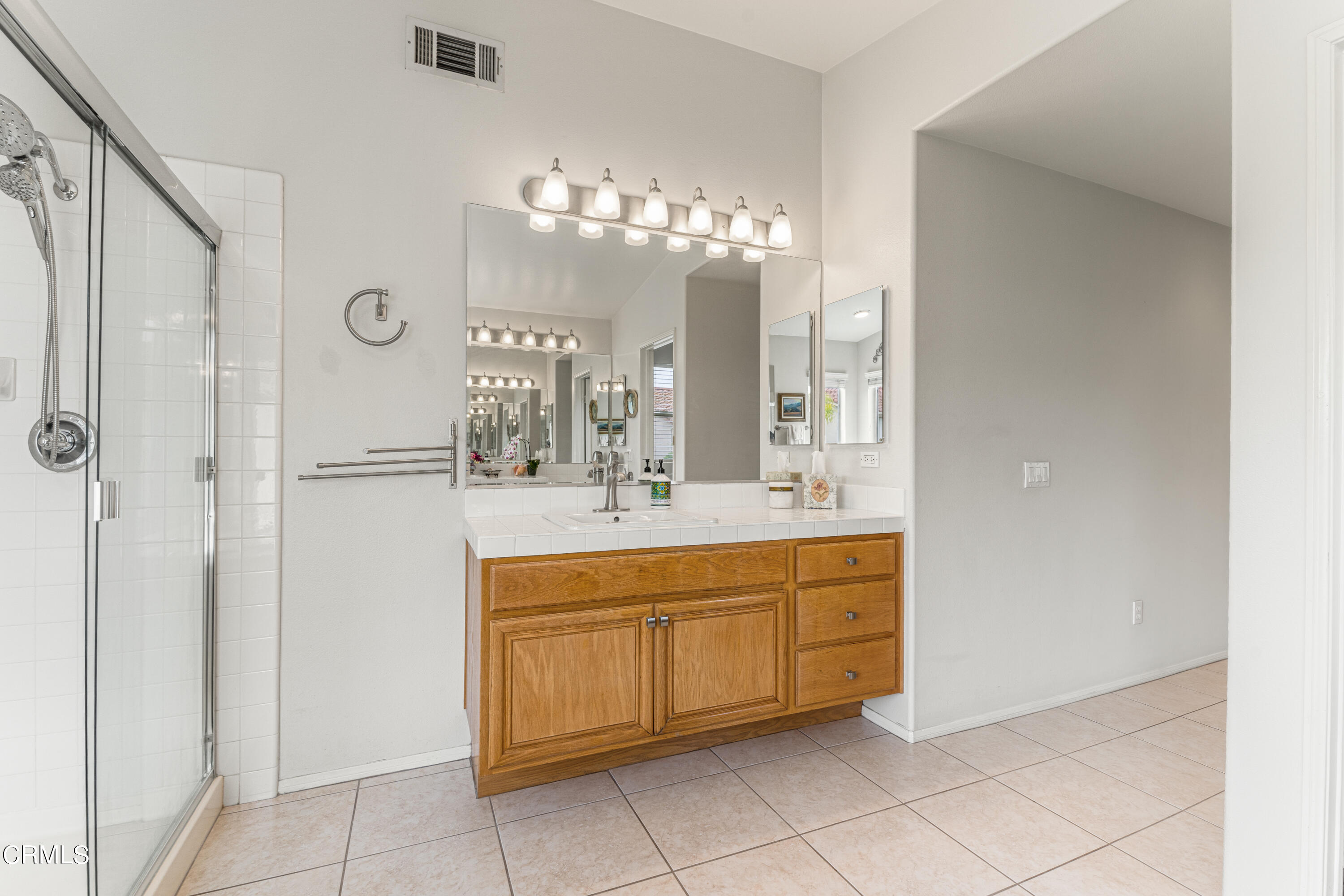 1555 Corte Olivas Camarillo, CA 93012 - Photo 23 of 45 a spacious bathroom with a double vanity sink and a mirror