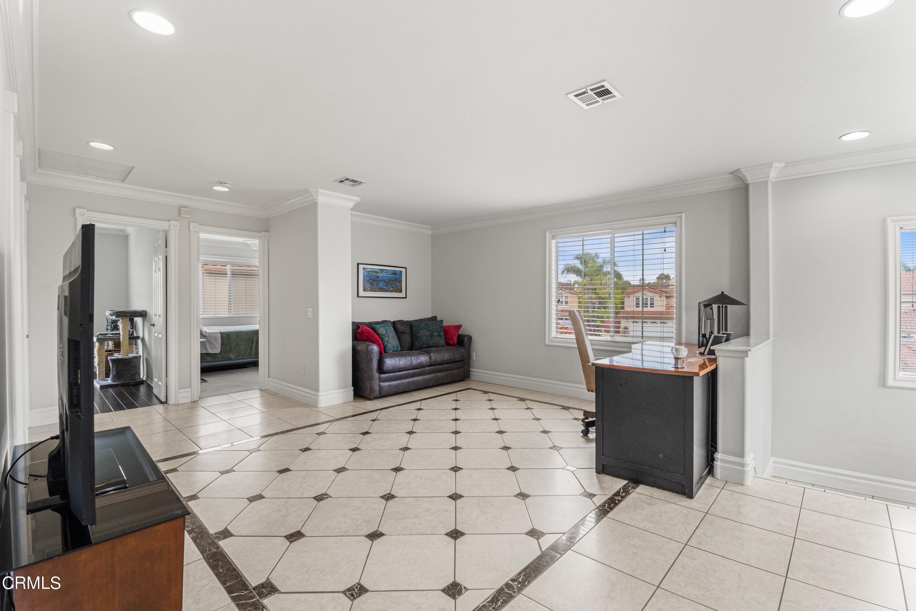 1555 Corte Olivas Camarillo, CA 93012 - Photo 32 of 45 a living room with furniture a flat screen tv and a refrigerator