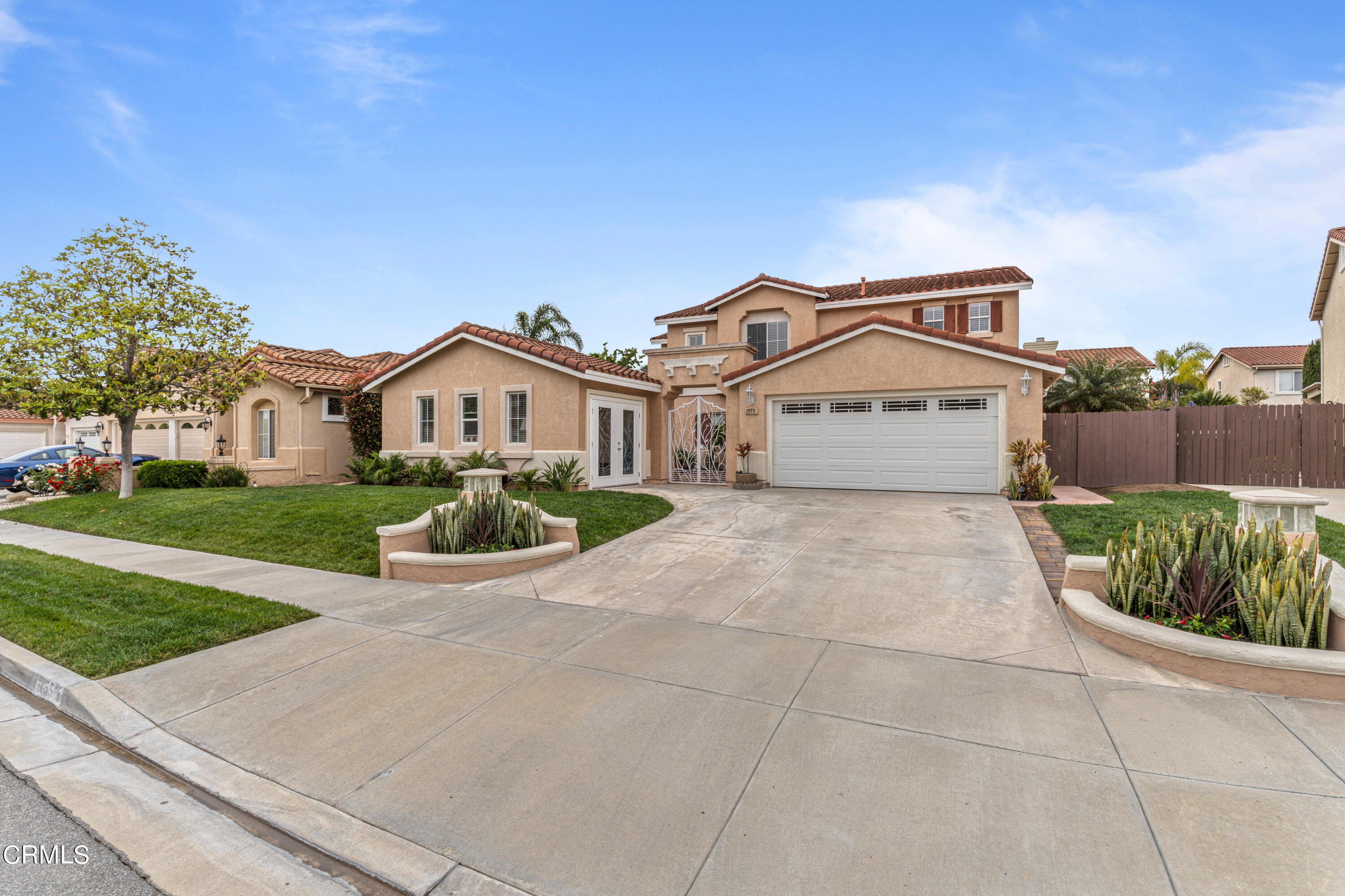 1555 Corte Olivas Camarillo, CA 93012 - Photo 45 of 45 a front view of a house with a yard and potted plants