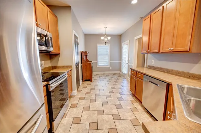 a view of a kitchen with furniture and a refrigerator