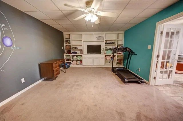 a hallway with a couch and chandelier