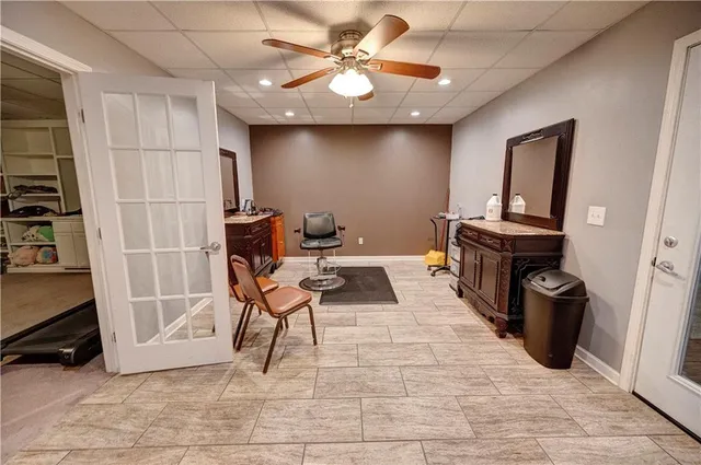 en empty room with windows and fan