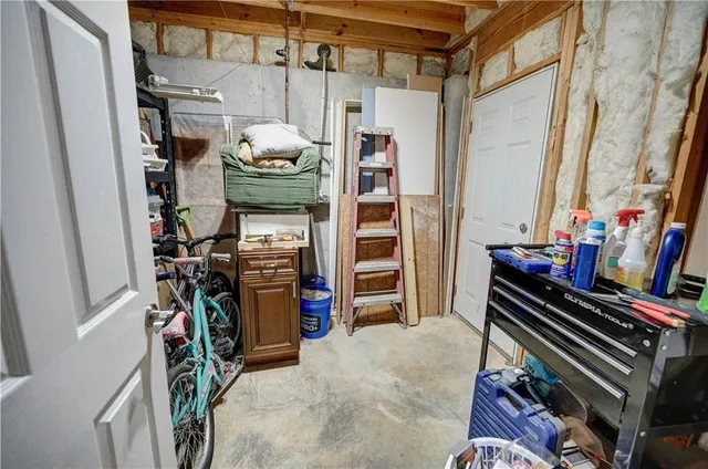 a view of a white house next to a yard with big trees