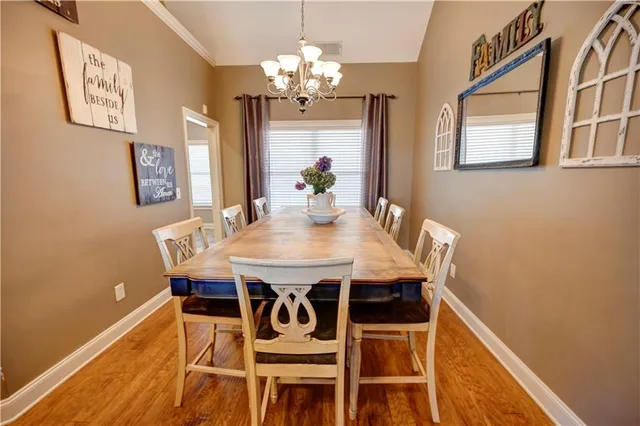 a view of a dining room with furniture and a chandelier