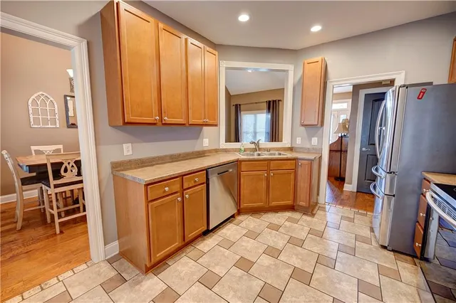 a kitchen with stainless steel appliances granite countertop a refrigerator and a sink